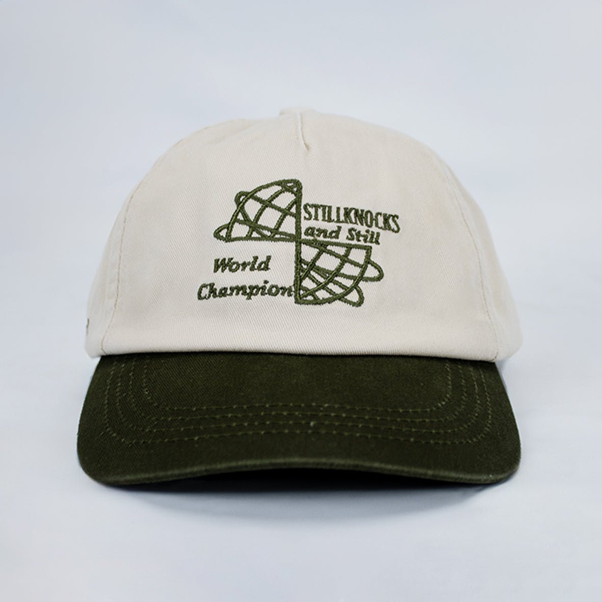 Stillknocks World Champion Two-Tone Dad Cap: Ivory Cotton Twill, Embroidered Globe