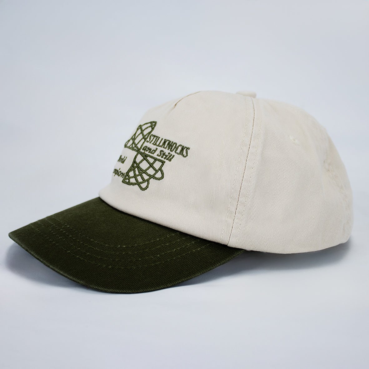 Stillknocks World Champion Two-Tone Dad Cap: Ivory Cotton Twill, Embroidered Globe