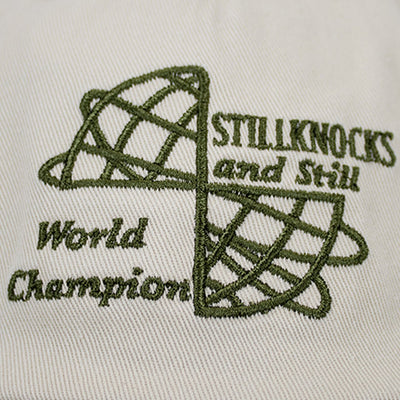 Stillknocks World Champion Two-Tone Dad Cap: Ivory Cotton Twill, Embroidered Globe